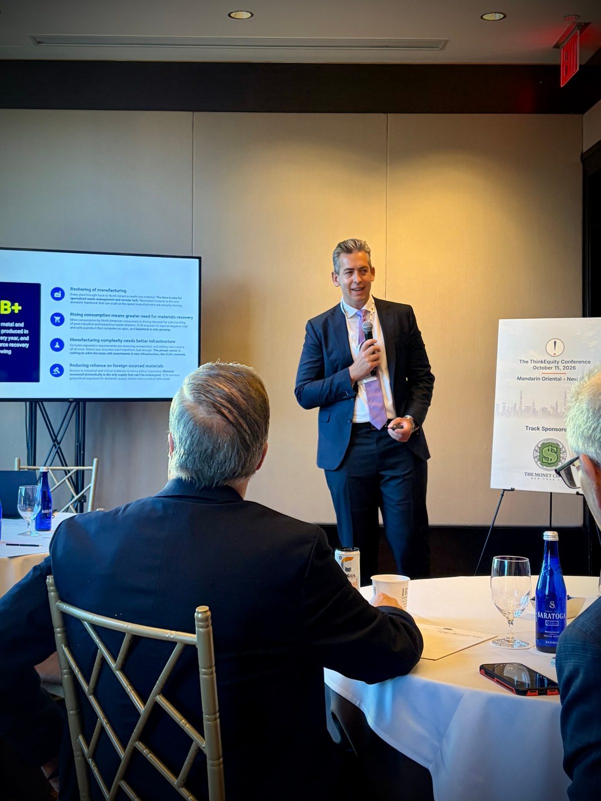 CLN executive presenting to an audience at a conference